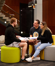 Three students sitting and talking